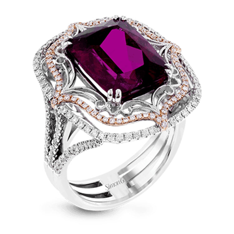 This vintage-inspired two-tone 18k gold ring centers on an extraordinary 7.03 rubellite stone which is surrounded by .67 ctw of white diamonds.