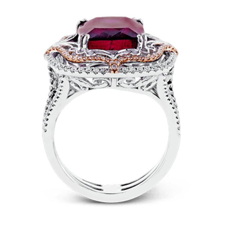This vintage-inspired two-tone 18k gold ring centers on an extraordinary 7.03 rubellite stone which is surrounded by .67 ctw of white diamonds.