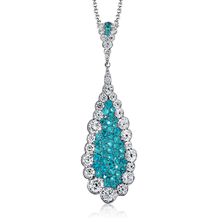 This pendant's stunning .50 ctw of blue paraiba instantly grabs all the attention in the room and is surrounded by 1.10 ctw of round brilliant white diamonds.