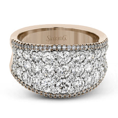 This bold statement ring is made from 18k rose and white gold and contains 2.01 ctw of white round brilliant diamonds as well as .23 ctw of pink diamonds.