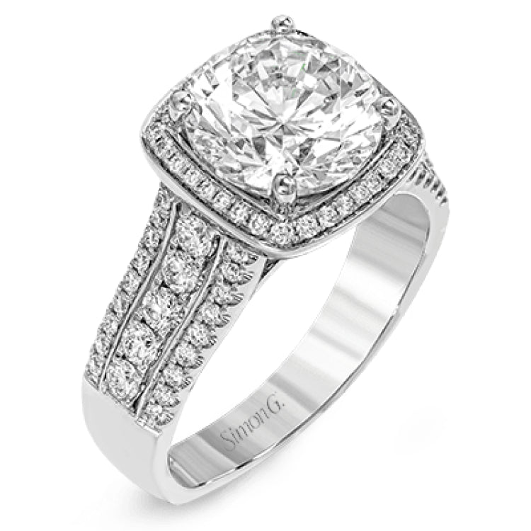 This eye-catching modern white gold ring is accentuated by an elegant halo highlighted with .64 ctw of round cut white diamonds.