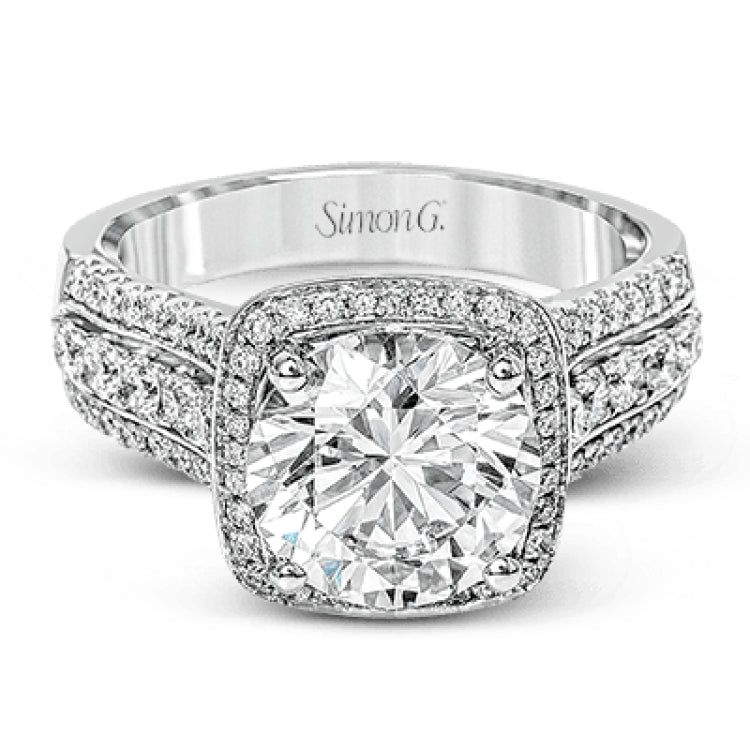 This eye-catching modern white gold ring is accentuated by an elegant halo highlighted with .64 ctw of round cut white diamonds.