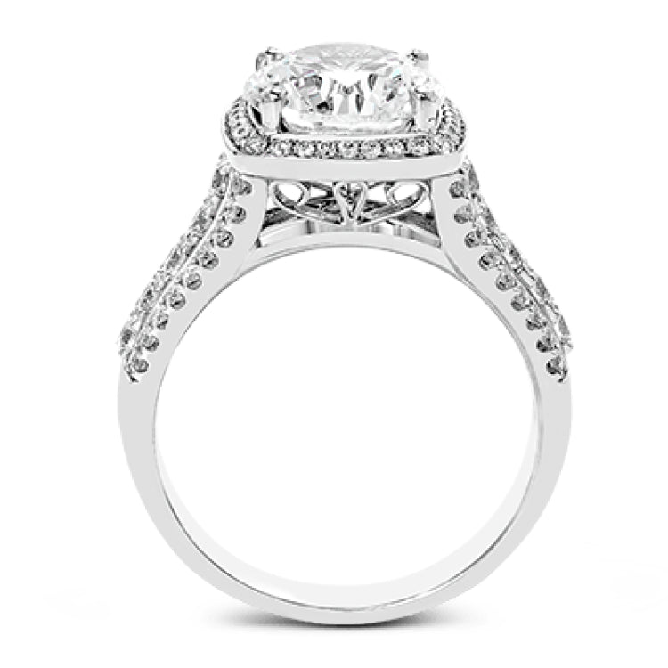 This eye-catching modern white gold ring is accentuated by an elegant halo highlighted with .64 ctw of round cut white diamonds.