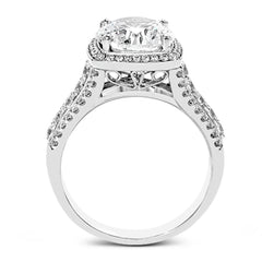 This eye-catching modern white gold ring is accentuated by an elegant halo highlighted with .64 ctw of round cut white diamonds.