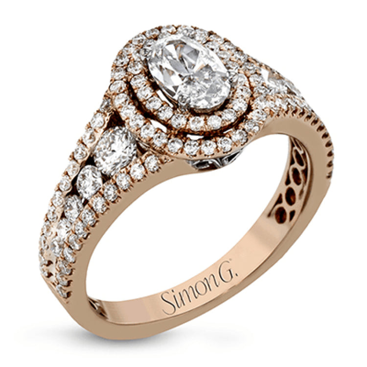 Featuring an exquisite contemporary design, this white gold engagement ring features an eye-catching oval double halo complemented by .68 ctw of round cut white diamonds.