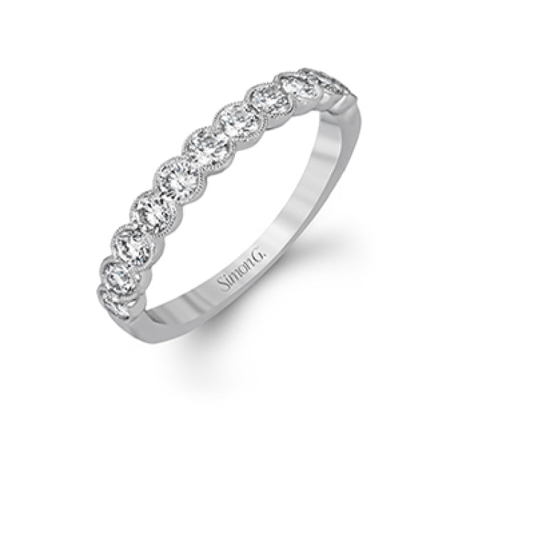 This engagement and wedding band set combines old and new with 1.09 ctw of round brilliant diamonds bezel set into 18k white gold, accented with vintage-inspired milgrain.