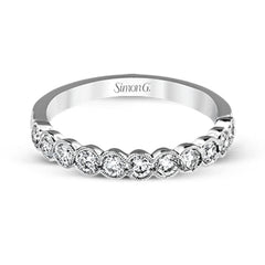This engagement and wedding band set combines old and new with 1.09 ctw of round brilliant diamonds bezel set into 18k white gold, accented with vintage-inspired milgrain.