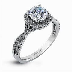 Presenting a lovely twisted shank design, this contemporary white gold engagement ring and wedding band set is accentuated with .44 ctw round cut white diamonds.