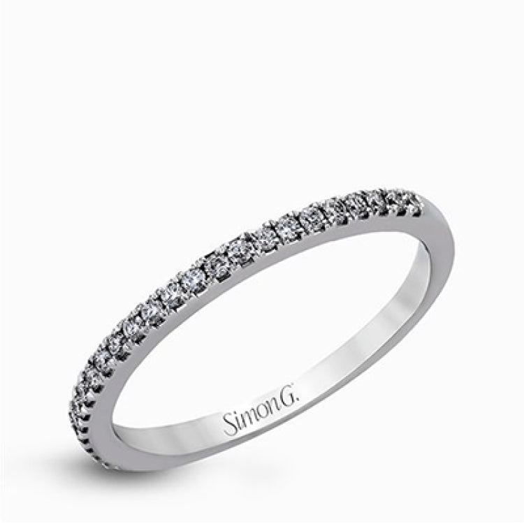 This eye-catching contemporary white gold engagement ring and wedding band set features an impressive halo accented by .63 ctw round cut white diamonds.
