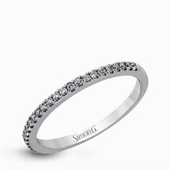 This eye-catching contemporary white gold engagement ring and wedding band set features an impressive halo accented by .63 ctw round cut white diamonds.
