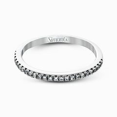 This eye-catching contemporary white gold engagement ring and wedding band set features an impressive halo accented by .63 ctw round cut white diamonds.