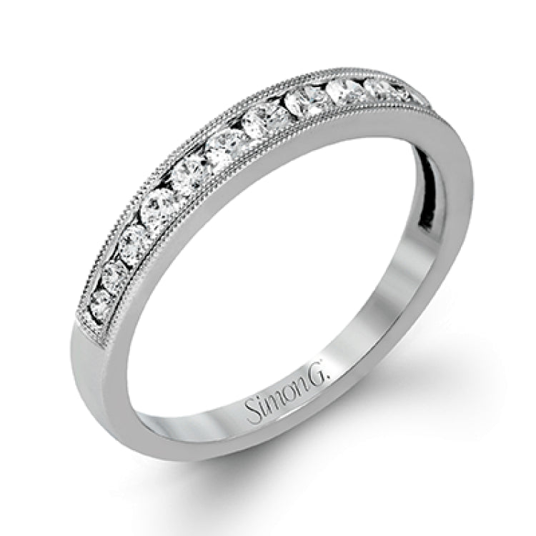This dramatic contemporary white gold ring is accentuated by .37 ctw round cut white diamonds and features .30 ctw glimmering side stones.