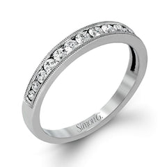 This dramatic contemporary white gold ring is accentuated by .37 ctw round cut white diamonds and features .30 ctw glimmering side stones.