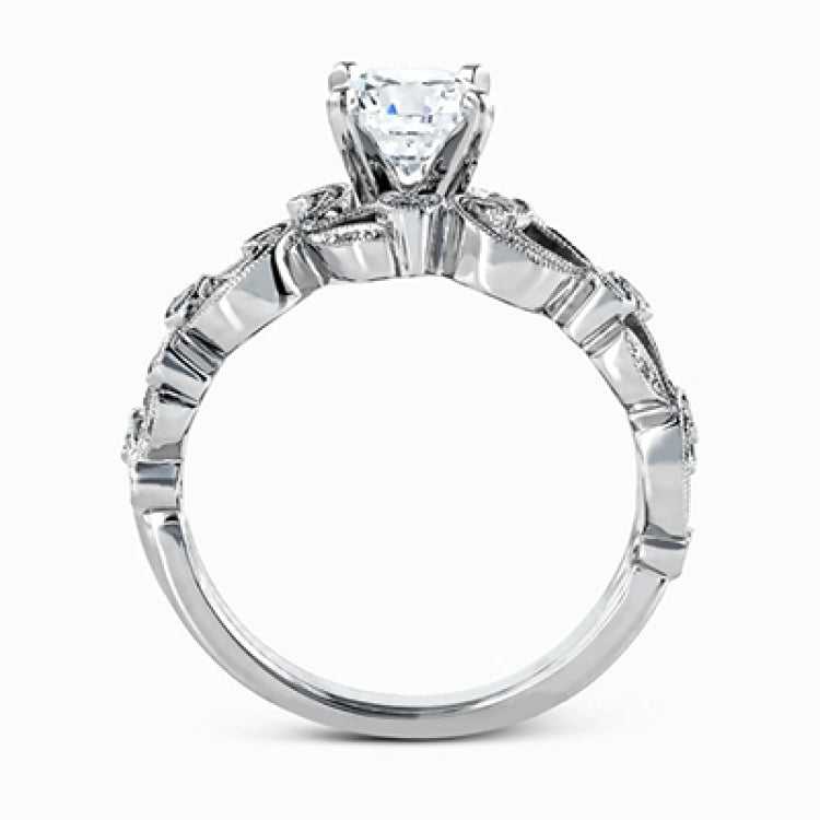 This delicate floral inspired white gold engagement ring and wedding band set is accentuated with .28 ctw shimmering round cut white diamonds.