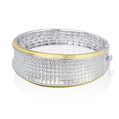 Offering a distinctive contemporary style, this bangle bracelet is white and rose gold is accented by an astounding 18.85 ctw princess cut white diamonds and .79 round pink diamonds.