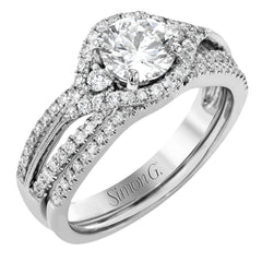 Featuring a modern design, this rose and white gold engagement ring and wedding band is highlighted by .51 ctw of round cut white diamonds.