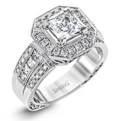 The dramatic contemporary design of this white gold ring is highlighted by .59 ctw of round cut white diamonds and .36 ctw princess cut diamonds.