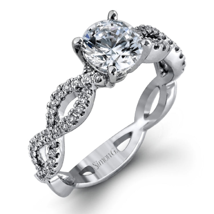 The intricate twisted design of this modern white gold engagement ring and wedding band set is set with .65 ctw of striking round cut white diamonds.