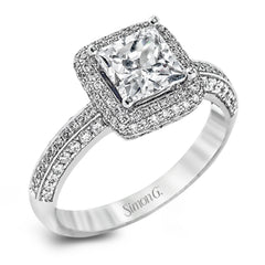 This vintage-inspired 18k white gold engagement ring is the perfect design for princess cut center stone because it has a detailed square shaped halo. The entire ring is set with .62 ctw of white diamonds.