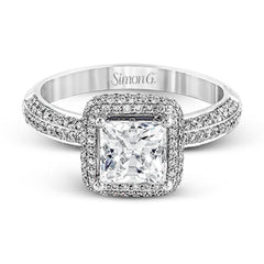 This vintage-inspired 18k white gold engagement ring is the perfect design for princess cut center stone because it has a detailed square shaped halo. The entire ring is set with .62 ctw of white diamonds.
