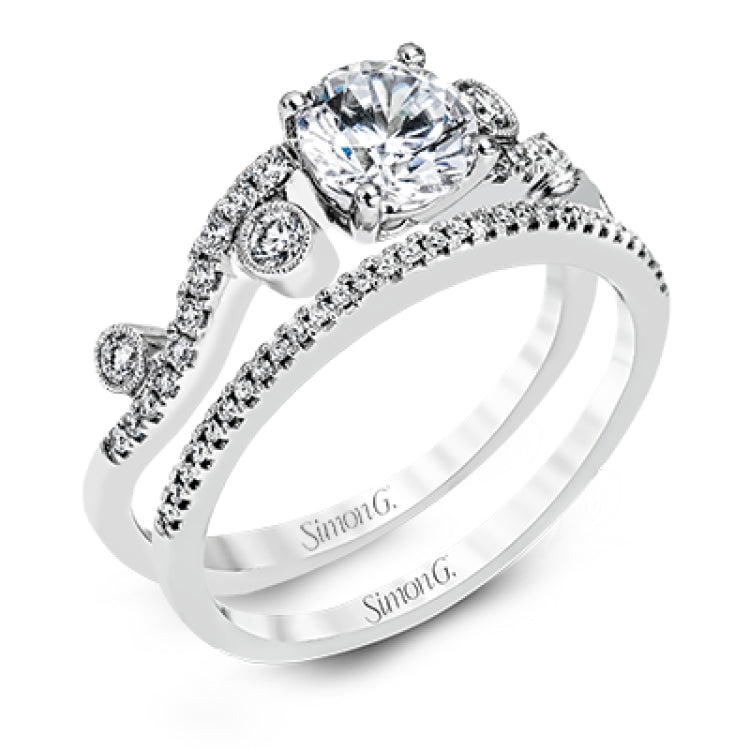 Playful and modern, this white gold wedding set sparkles with .31 ctw of round white diamonds highlighting the center stone.