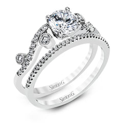 Playful and modern, this white gold wedding set sparkles with .31 ctw of round white diamonds highlighting the center stone.