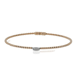Simple and sweet, this 18k white and rose gold bangle is perfect worn alone or stacked and features .04cttw diamonds.
