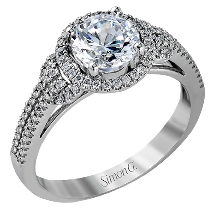 This 18k white gold ring contains .30 ctw of side diamonds set within its classic halo design.
