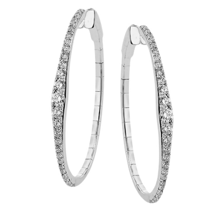 A fresh take on the diamond hoops in 18K white gold 1.11 ctw, they taper at the ends and feature larger diamonds in the center graduating to small towards the ends.