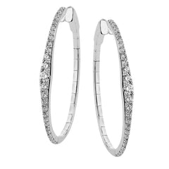 A fresh take on the diamond hoops in 18K white gold 1.11 ctw, they taper at the ends and feature larger diamonds in the center graduating to small towards the ends.