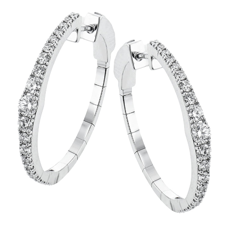 Dress up your classic button down with these 18K white gold hoops featuring .97cttw diamonds.