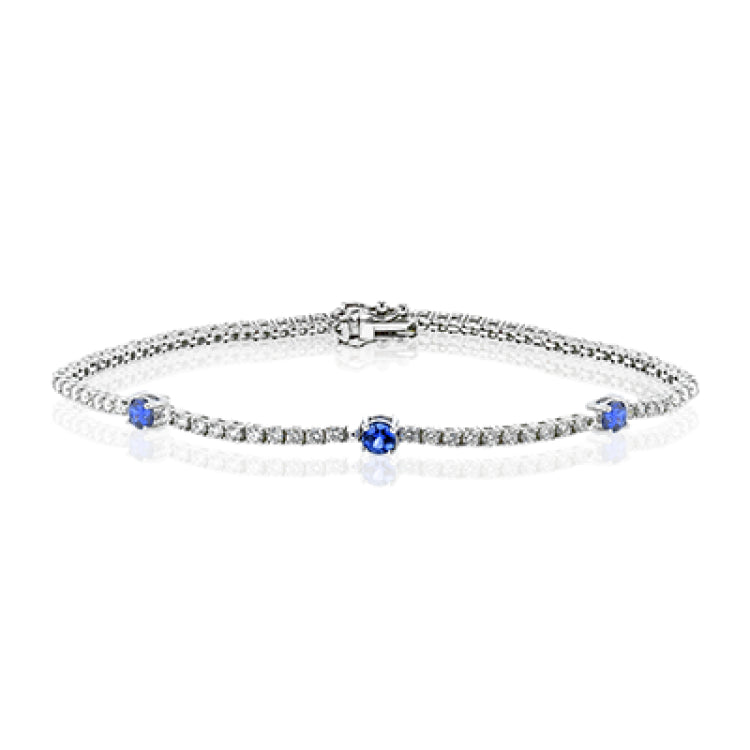 This eminently wearable 18k white gold bracelet features three blue sapphire accents that total .60 ctw.