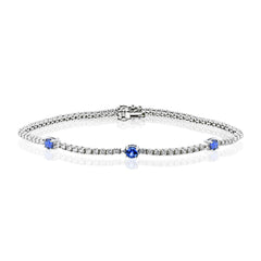 This eminently wearable 18k white gold bracelet features three blue sapphire accents that total .60 ctw.