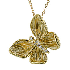 A shining golden butterfly sparkles with .06 ctw of white diamonds in this wonderful 18k gold pendant.