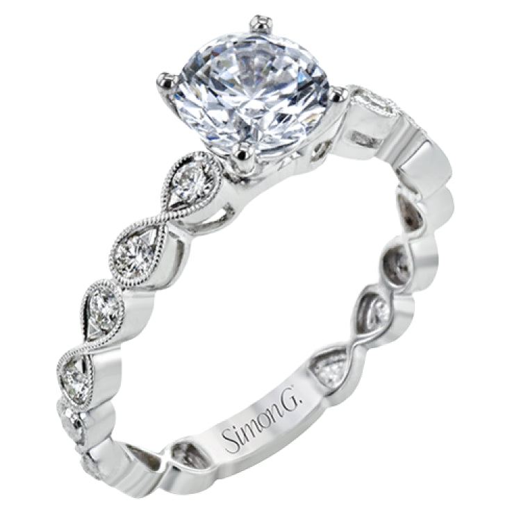 This wedding set features a white gold vintage inspired engagement ring in the center with a yellow gold granulated ring guard that provides a unique look.