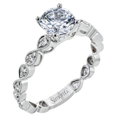 This wedding set features a white gold vintage inspired engagement ring in the center with a yellow gold granulated ring guard that provides a unique look.