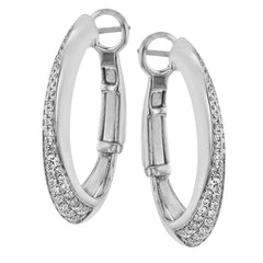 These dynamic 18k white gold hoop earrings contain .27 ctw of white diamonds along the exterior of their distinctive shape.