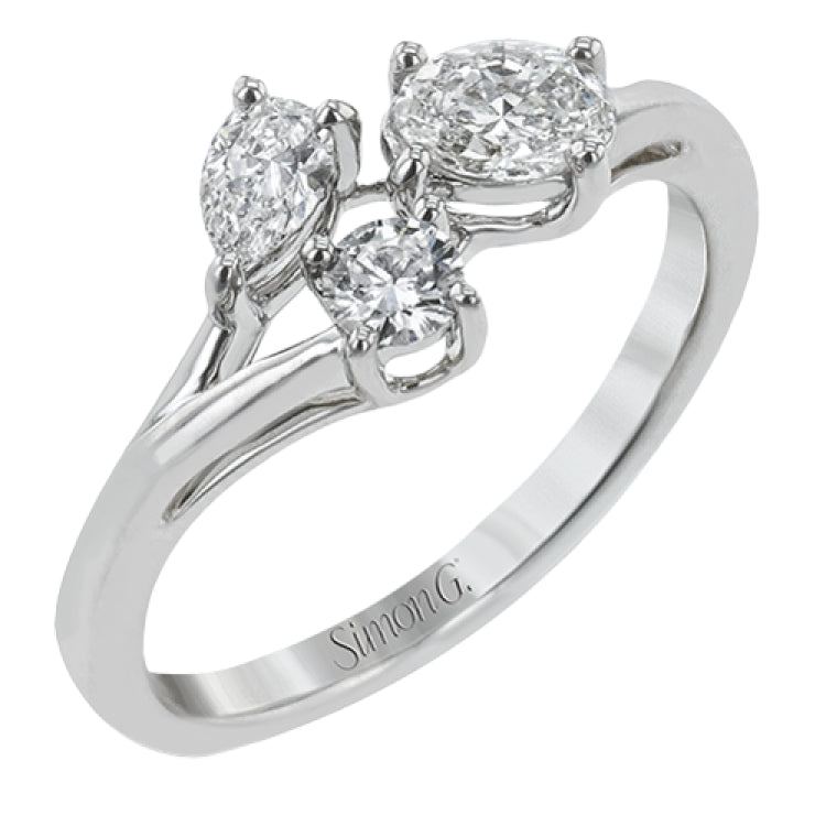 Our modern update on the three stone ring, this piece features a round, pear, and oval diamond brought together in a stunning design.