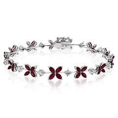 This bracelet charms with a floral design set with 3.58 ctw of rubies and .96 ctw of white diamonds.