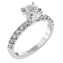 This distinctive bridal set design features a double-layer wedding band that fits around the engagement ring. The set contains .77 ctw of white diamonds.