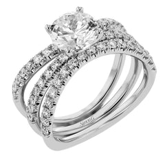 This distinctive bridal set design features a double-layer wedding band that fits around the engagement ring. The set contains .77 ctw of white diamonds.