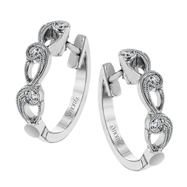These beautiful white gold earrings feature an intricate scrolling design with .11 ctw of round white diamonds for just a hint of sparkle.