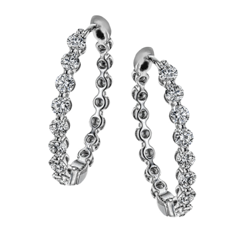 These elegant white gold hoops sparkle with .99 ctw of white diamonds
