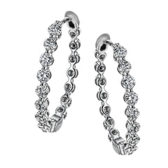 Dazzling yet refined, these white gold hoops showcase an impressive 1.51 ctw of white diamonds