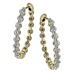 Dazzling yet refined, these yellow gold hoops showcase an impressive 1.51 ctw of white diamonds
