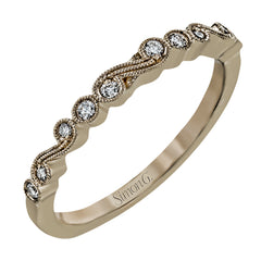 This vintage inspired 18k rose gold ring contains .12 ctw of round white diamonds in a delicate swirling design. Perfect for stacking.