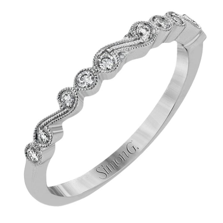 This vintage inspired 18k white gold ring contains .11 ctw of round white diamonds in a delicate swirling design. Perfect for stacking.