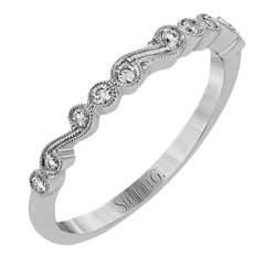 This vintage inspired 18k white gold ring contains .11 ctw of round white diamonds in a delicate swirling design. Perfect for stacking.