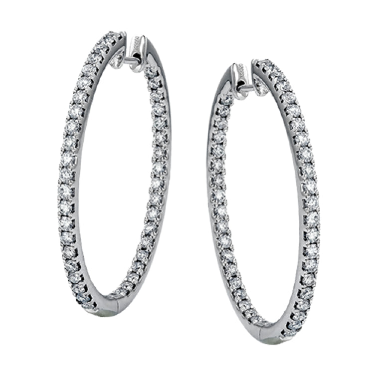 Dramatic yet refined, these white gold earrings contain 1.52 ctw of white diamonds