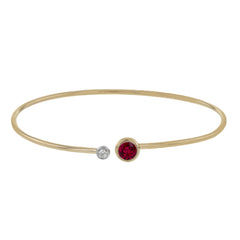 This understated rose gold bangle features a subtle .08 ctw white diamond accent opposite a stunning .73 ctw ruby. Perfect for stacking.